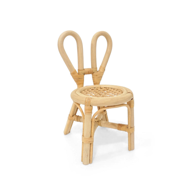 The Poppie Mini Bunny Chair Set by poppie toys features a small rattan chair with a woven seat and bunny ear backrest—an adorable kids’ furniture piece to add playful charm to tea parties or any cozy space.