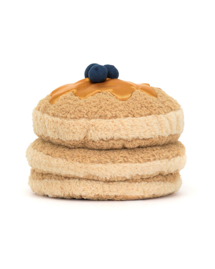 Introducing Jellycats Amuseables Fran Pancakes, a plush toy with fluffy golden fur, resembling two delightful pancakes complete with syrup and textured blueberries.