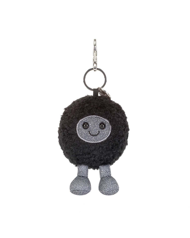 The Jellycat Amuseables Black Hole Bag Charm is a plush, round black creature with a smiling gray face and glittery legs, attached to a silver keyring and clasp—an adorable space-themed accessory or playful physics gift.