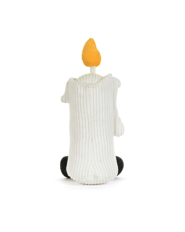 Meet the Jellycat Amuseables Flickerty Candle: an adorable plush shaped like a white candle with a yellow flame on top, ribbed texture, two little black feet, and soft white arms. Sitting on a white background, it’s the perfect whimsical accent for spooktacular tablescapes or any Halloween party planner seeking a cozy touch.