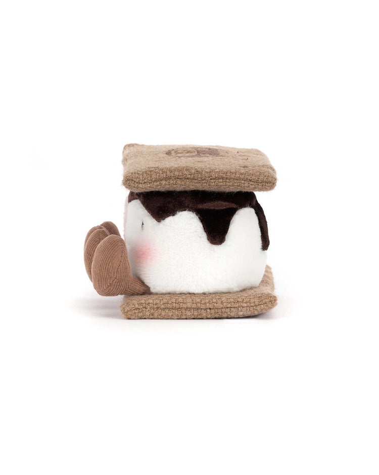 The Jellycat Amuseables S’mores plush features soft brown graham cracker layers, a white marshmallow center, dark chocolate detailing, and a sweet smiling face—perfect as a cuddly campfire-themed toy.