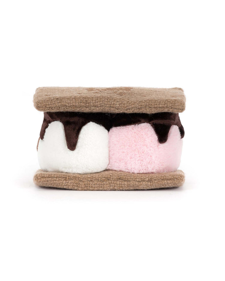 The jellycat amuseables s'mores plush toy features tan cookie-like layers, soft white and pink marshmallows, and a chocolate center, all shaped like a s’more and set against a white background.