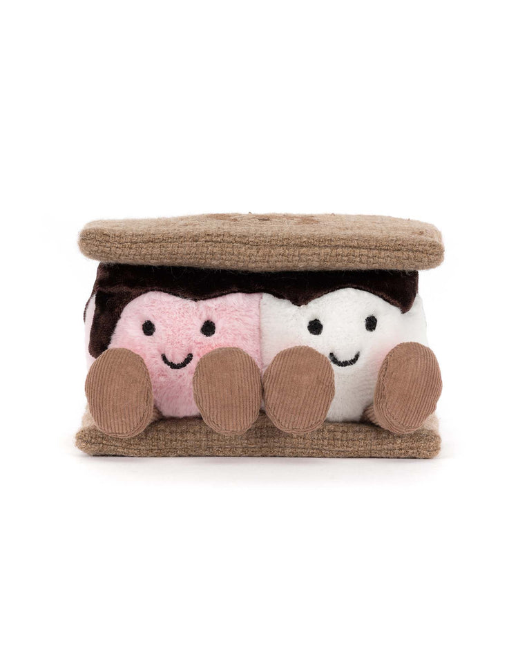 The Jellycat Amuseables S'mores plush toy features two smiling marshmallows, one pink and one white, nestled between soft brown crackers, with chocolate and round plush feet.
