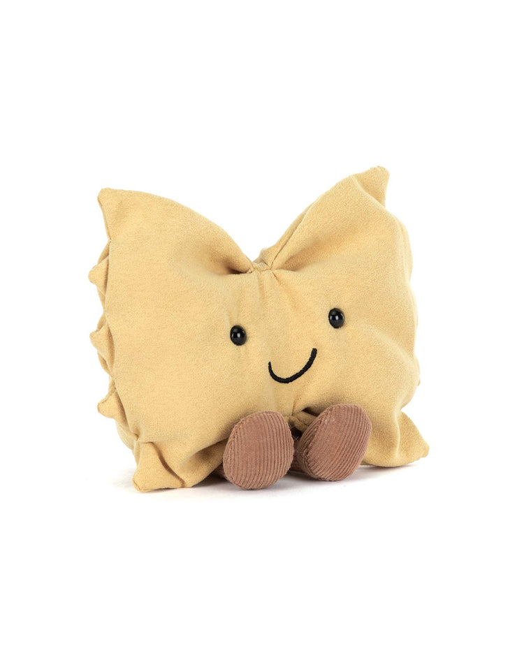 The amuseables farfalle by Jellycat is a delightful plush toy shaped like a smiling ravioli with little brown feet, making it the perfect pasta companion for any cuddle session.
