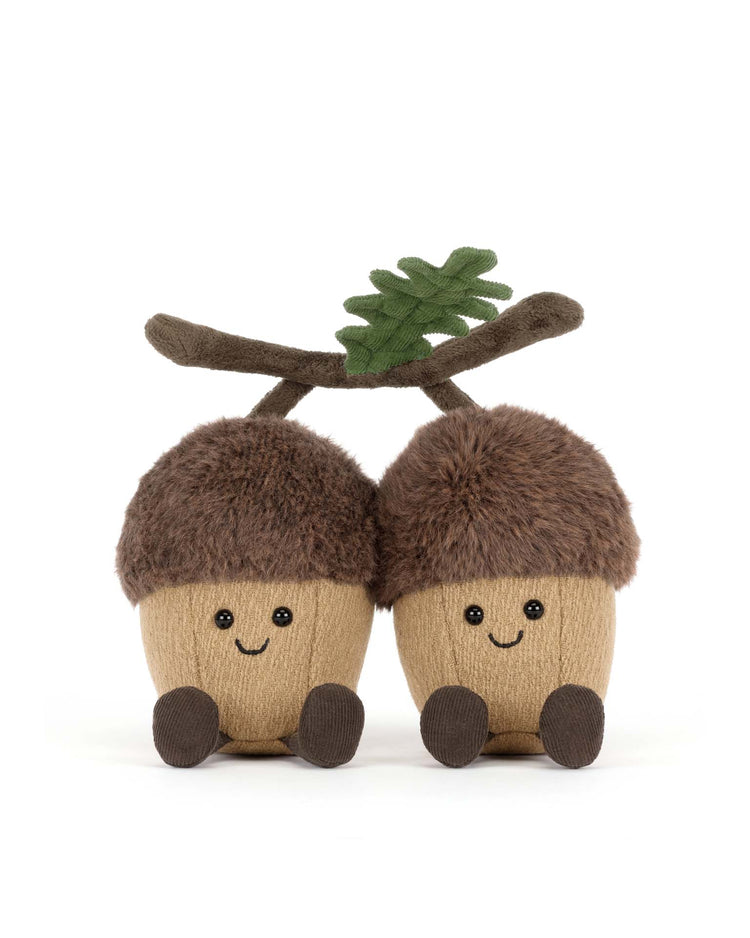 The Jellycat amuseables ort & tum acorns features two plush acorns with smiling faces, brown caps, and tiny feet, joined by a soft branch with a green leaf—a charming collectible for any stuffed animal fan.