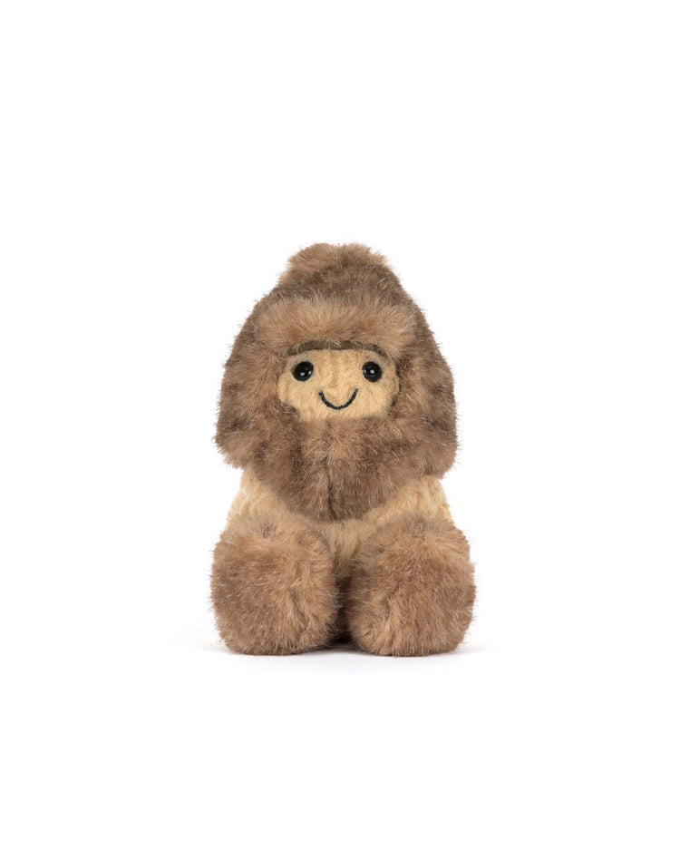 The Jellycat Amuseables Peanut Yeti Outfit is a small, plush toy featuring a seated, smiling peanut in a playful Yeti costume with a brown, fluffy body and dark eyes, photographed on a plain white background.