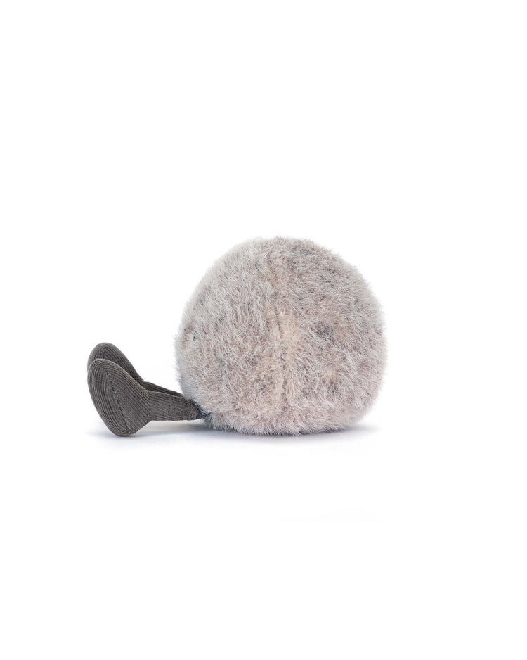 The amuseables pebble by jellycat is a plush toy shaped like a fluffy, round, light gray ball with a small textured gray stem on one side, shown against a plain white background.