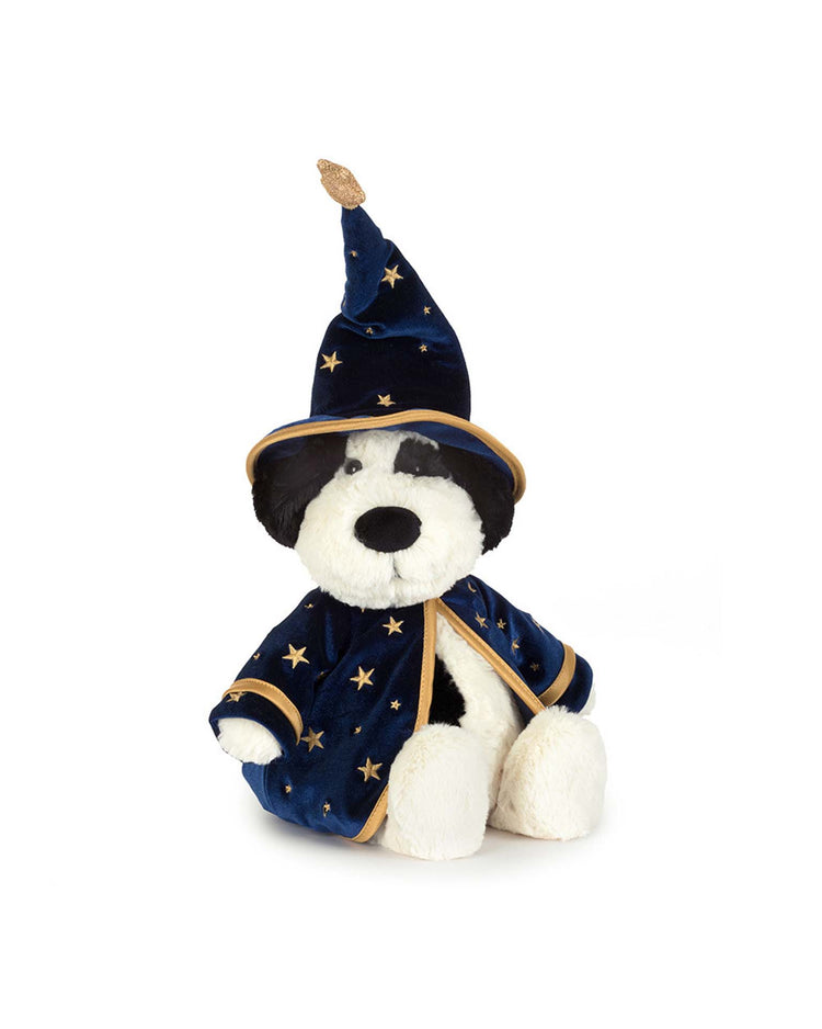 A Jellycat rufferty puppy plush toy sits upright against a white background, dressed in the charming rufferty puppy wizard outfit—a dark blue hat and robe adorned with gold stars. This enchanting stuffed animal is perfect for magical adventures and cozy snuggles alike.
