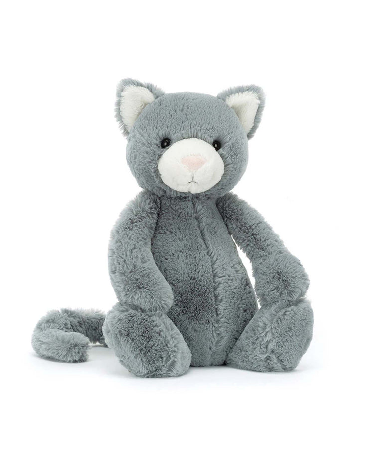 Meet the Jellycat Bashful Kitten Original, a charming plush cat toy with soft grey fur, a white snout, and inner ears. It sits upright, offering comfort and companionship to all who need it.