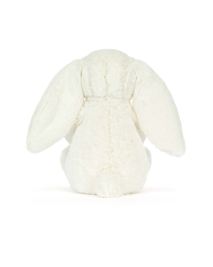 The jellycat cream bunny with star, featuring long floppy ears and seated with its back to the viewer against a plain white background, makes a delightful gift for special occasions.