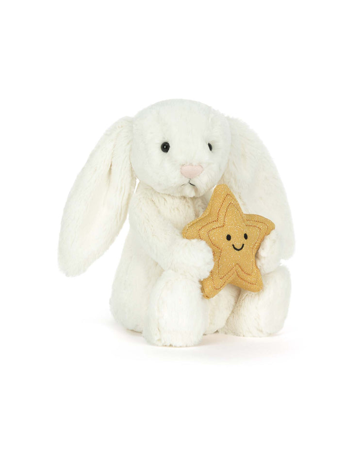 The jellycat cream bunny with star features floppy ears and holds a smiling yellow star plush, set against a plain white background—an adorable gift for milestones.