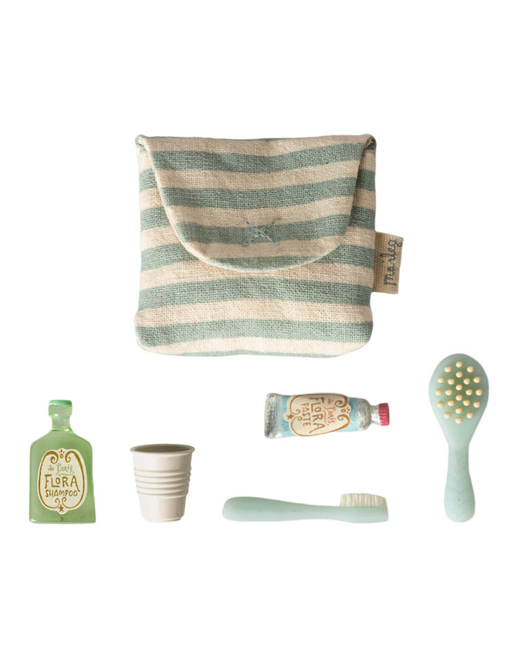 The maileg toothbrush set in bag, mouse - blue stripe includes a striped pouch with playset accessories: green shampoo bottle, cup, toothpaste tube, toothbrush, and light green hairbrush—ideal for your mouse family's bedtime routine.