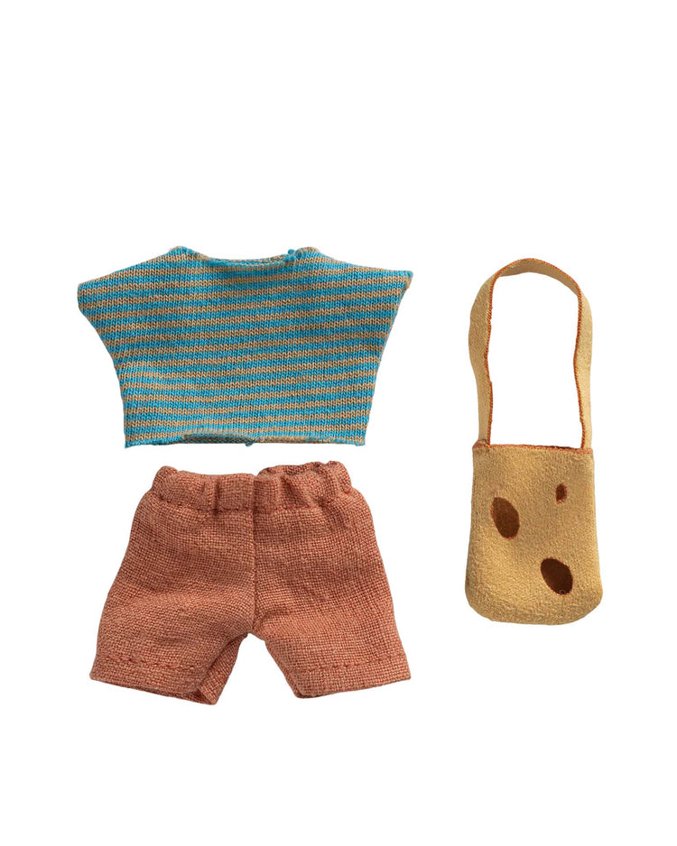 The Maileg clothes and bag for little brother mouse set includes a blue-yellow striped top, pink-orange shorts, and a tan shoulder bag with three holes, all shown on a white background.