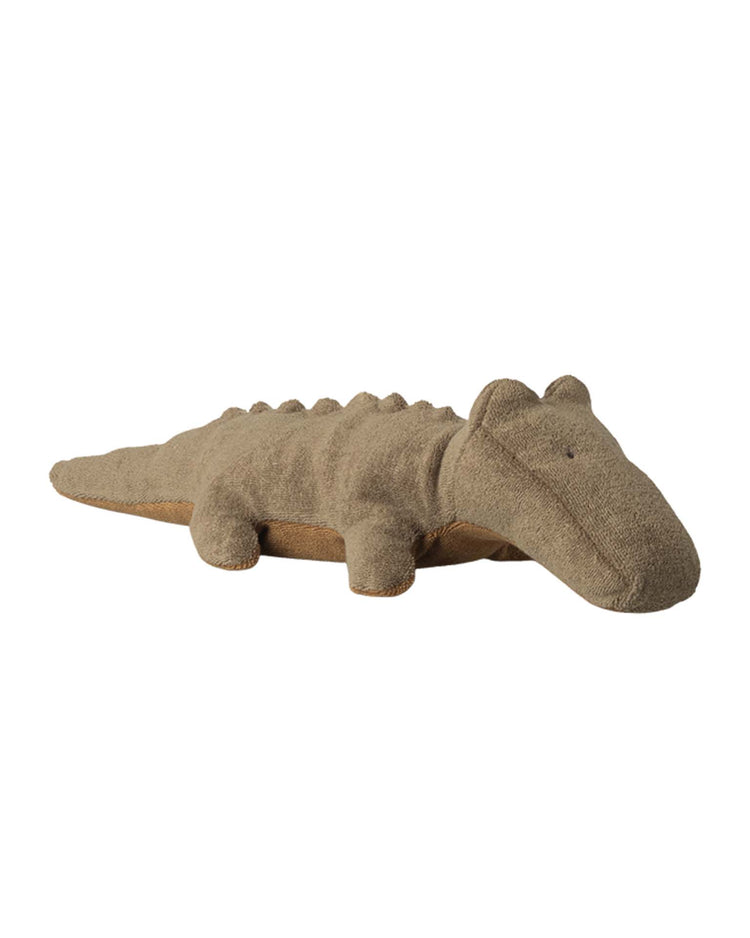 The Maileg small crocodile in olive green from the Safari Friends collection is a huggable plush toy featuring textured fabric, round eyes, short legs, and back bumps, shown lying on a plain white background.