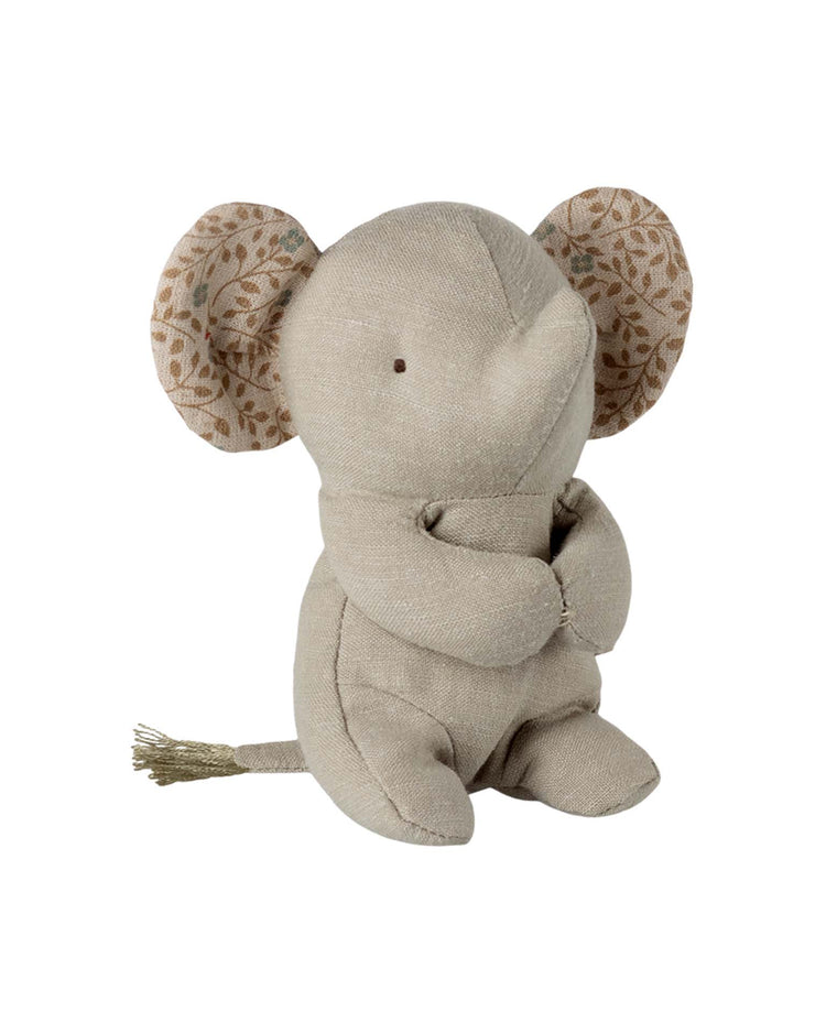 The maileg lullaby friends, elephant, mini - iron grey is a soft toy with patterned inner ears and a short tail. This plush elephant sits upright and features simple stitched details, making it a perfect gift for newborns.