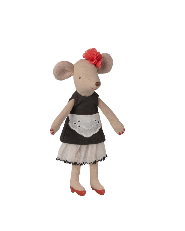 The beautician mum mouse by maileg is a stylish toy dressed as a beautician, featuring a black dress, white apron, red shoes, and a red flower on its head.