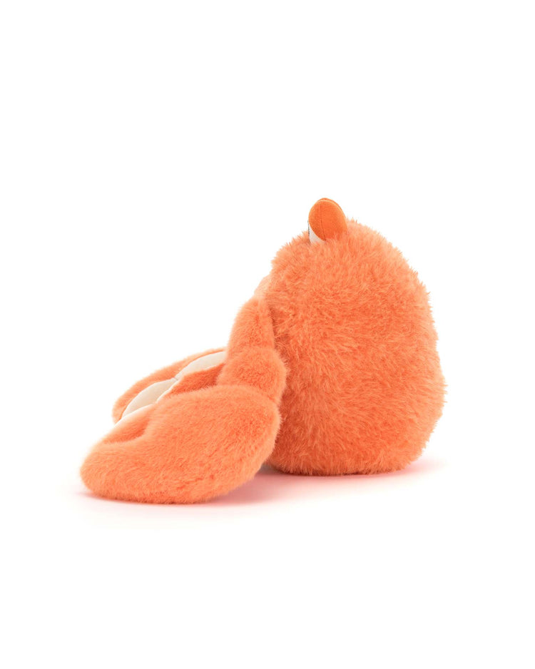 The jellycat pinchsnap crab is a soft, orange stuffed animal with long floppy ears lying on its side against a white background. Its face and details are hidden from view, making it perfect for anyone seeking ultimate comfort.