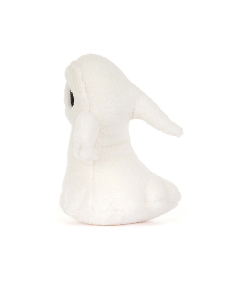 A jellycat ghost bob plush toy, crafted from soft white fabric and featuring a hood and small wings, is depicted sitting upright and facing left against a plain white background.