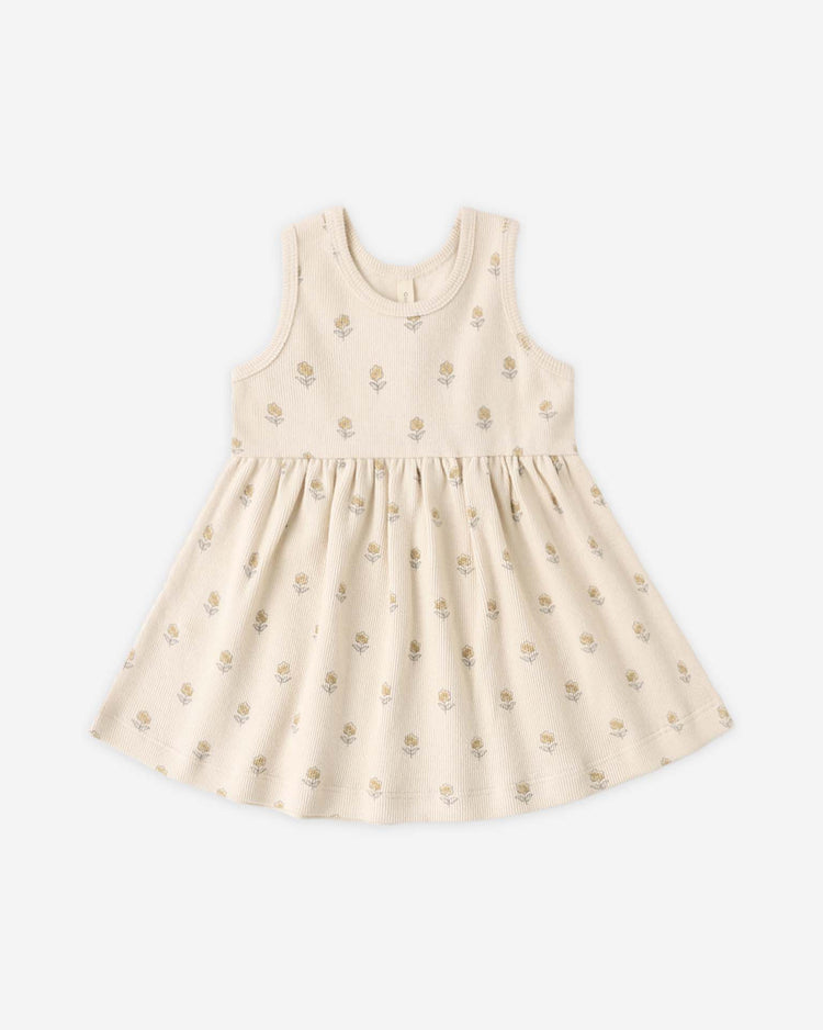 The quincy mae ribbed tank dress in buttercup is a sleeveless, cream-colored toddler dress with a round neckline, flared skirt, and subtle light brown floral print. Made from soft organic cotton, it's shown laid flat on a plain white background.