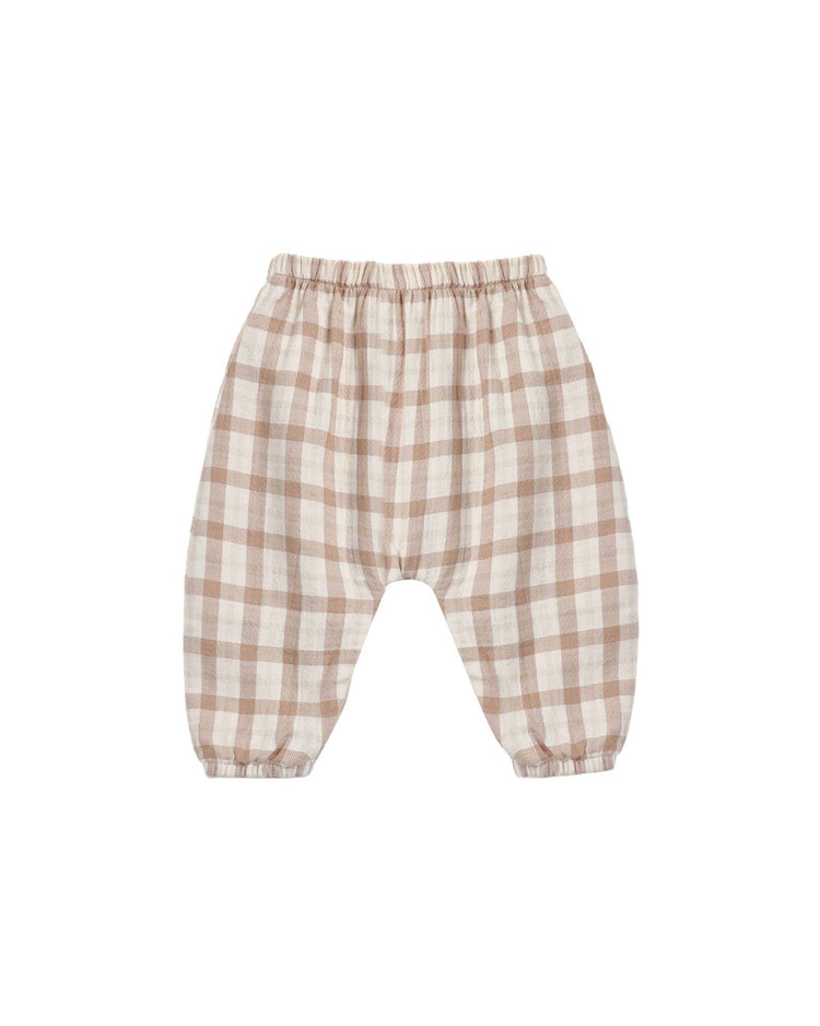 The woven pant in rustic plaid by quincy mae is crafted for babies from soft organic cotton, featuring a relaxed fit with an elastic waistband and elastic cuffs at the ankles. Shown here in a brown and white plaid pattern on a white background.