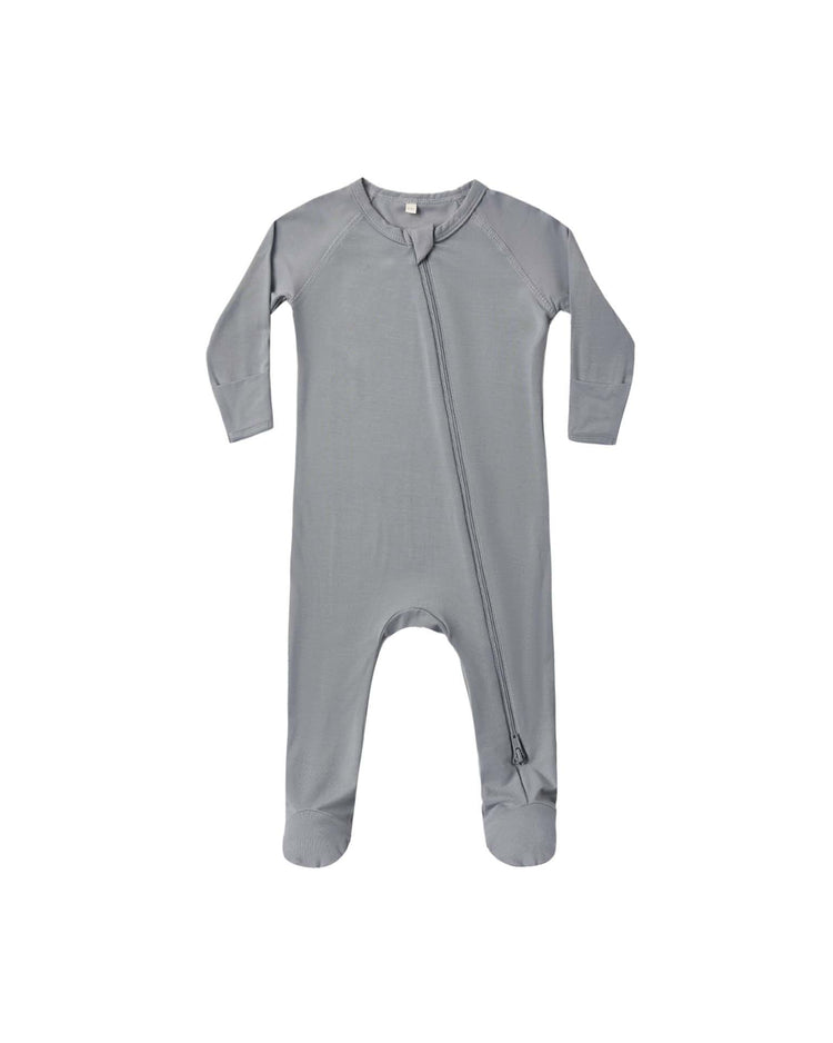 The quincy mae bamboo zip footie in slate is a gray long-sleeve baby onesie featuring footed legs and an asymmetrical double-zipper running from the neck down to one leg, perfect for cozy baby sleepwear and shown on a white background.