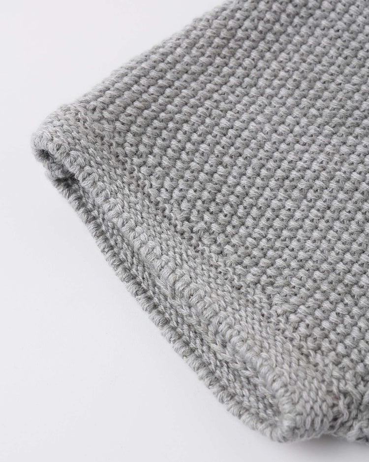 Close-up of the edge of quincy mae's summer knit set in heathered sky, highlighting the textured, tightly woven organic cotton stitches against a plain white background.