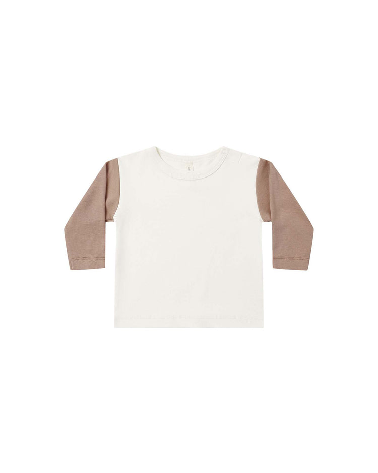 The quincy mae long sleeve raglan tee in almond is a children's top with an off-white body and light brown sleeves, made from soft organic cotton in a relaxed fit, shown on a plain white background.