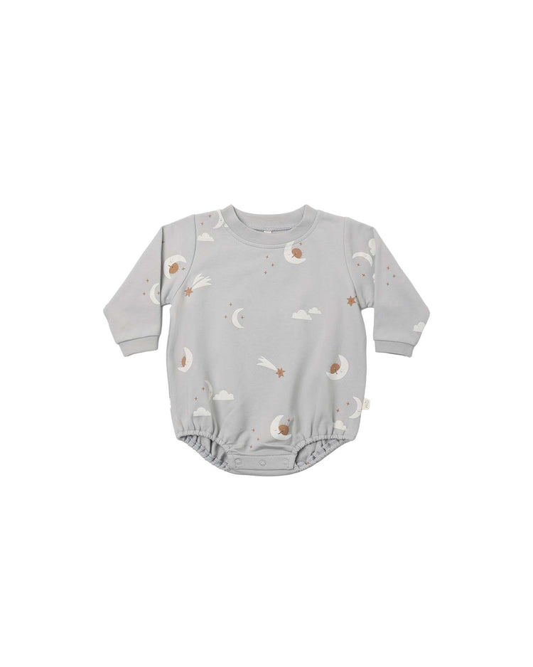 Quincy mae crewneck bubble romper in sky friends—gray long-sleeve organic cotton romper with a celestial pattern of moons, clouds, stars, and shooting stars—displayed on a plain white background.