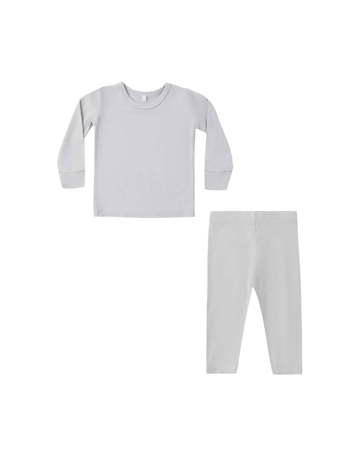 A slim-fit children's pajama set by quincy mae, the bamboo pajama set in cloud, features a light gray long sleeve tee and matching leggings made from soft bamboo fabric, shown on a white background.