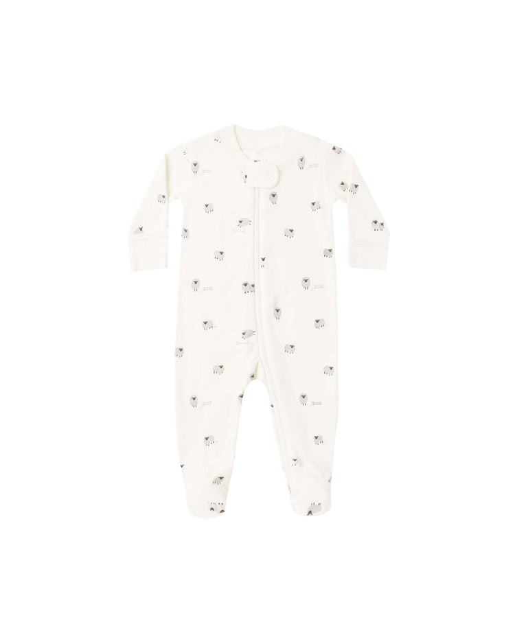 The Quincy Mae zip long sleeve sleeper footie in sheep features a charming pattern of small black and grey animal faces, with a convenient front zipper. This cozy white baby onesie is perfect for sleepwear, offering both comfort and style throughout the night.