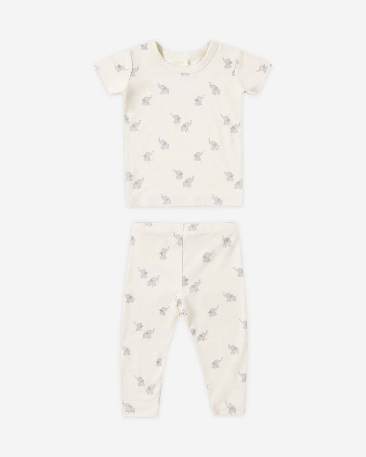 The quincy mae bamboo short sleeve pajama set in elephants, a soft matching children's shirt and pants duo with an elephant print, is shown laid flat on a white background.