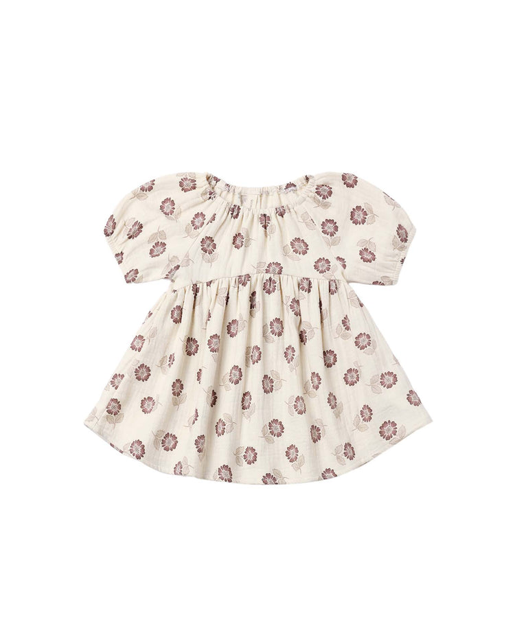 Introducing the bella dress in fall floral by quincy mae: a short-sleeved, cream-colored baby dress made from soft organic cotton, featuring a gathered neckline and skirt and adorned with an all-over pattern of small purple flowers.