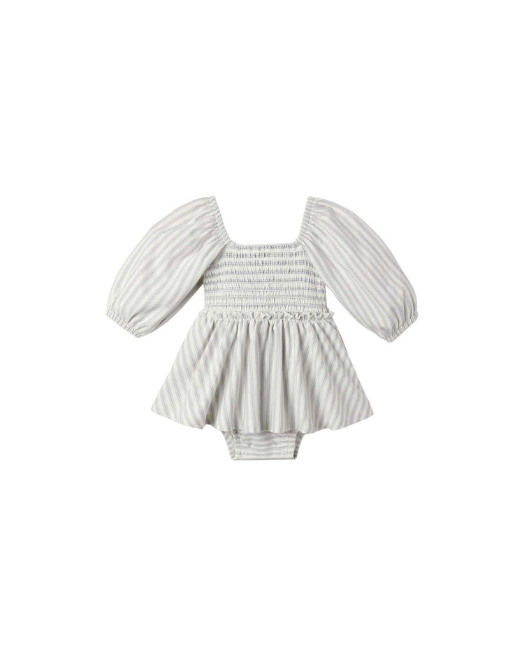 The Lainey Romper in Cloud Stripe by Quincy Mae features light gray and white stripes, puffed long sleeves, a smocked bodice, and an attached bloomer bottom, shown against a plain white background.