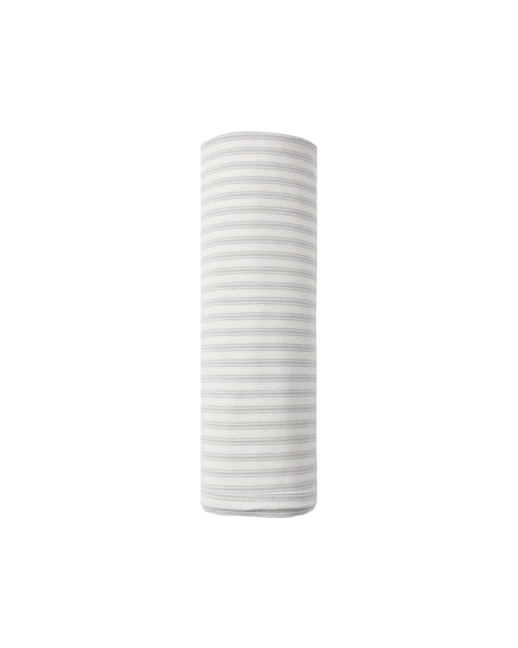 A rolled-up "swaddle in cloud stripe" by quincy mae, crafted from organic cotton and featuring thin, horizontal pastel stripes reminiscent of clouds, displayed upright against a plain white background.