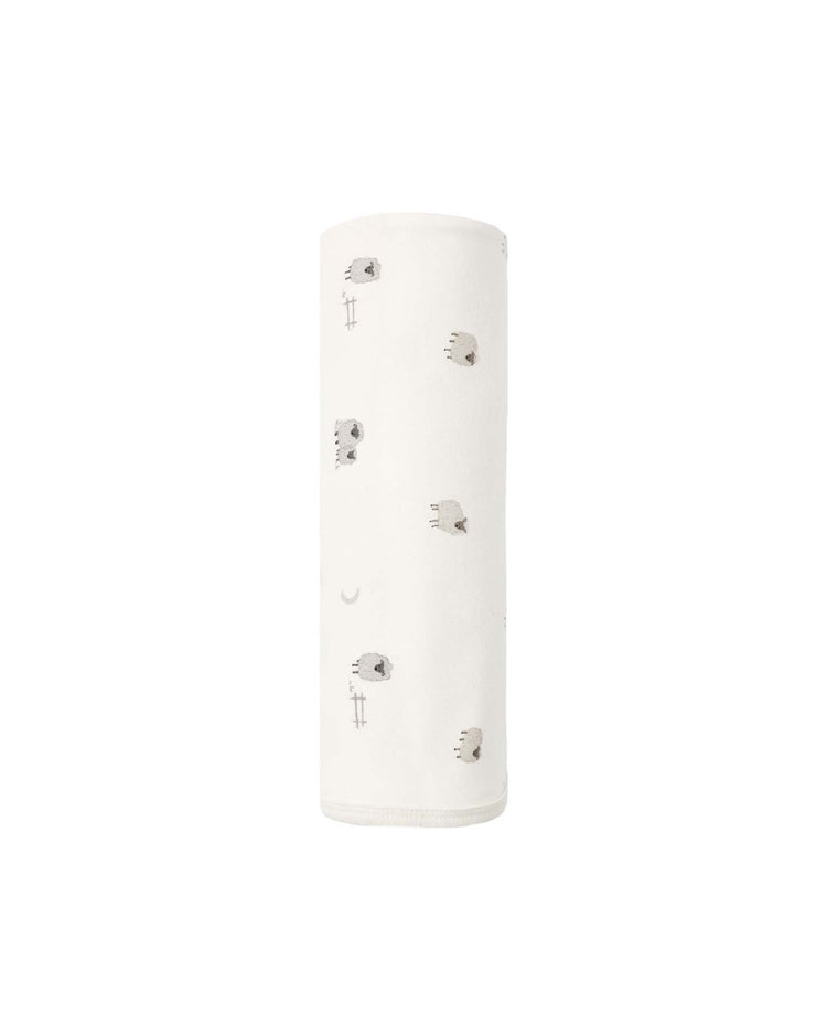 A rolled "swaddle in sheep" by quincy mae, made from soft organic cotton and featuring small gray sheep with subtle line designs, is displayed on a plain white background.