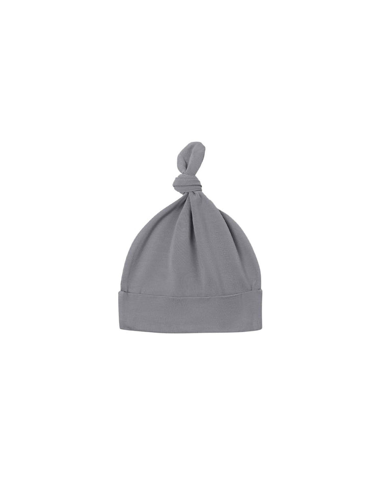 The quincy mae knotted baby hat in slate is a soft, light gray hat made from organic cotton, featuring a folded brim and a charming top knot, displayed on a plain white background.