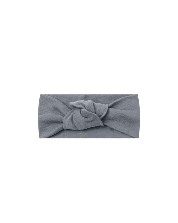 The knotted headband in slate by quincy mae features a central twisted knot design, crafted from soft organic cotton and displayed flat on a white background—making it an ideal baby accessory for everyday wear.