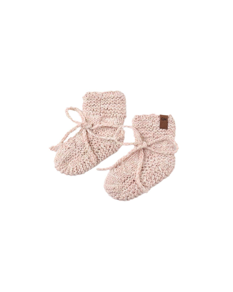 A pair of quincy mae knit booties in dusty rose speckle, featuring ankle ties laced in bows, are placed side by side on a plain white background.