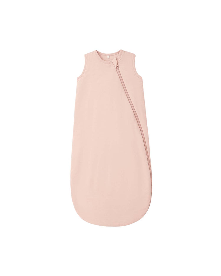 A sleeveless Bamboo Sleep Bag in dusty rose by Quincy Mae, featuring a rounded bottom and a diagonal zipper starting near the shoulder, crafted from breathable bamboo to keep your baby cozy and comfortable all night long.