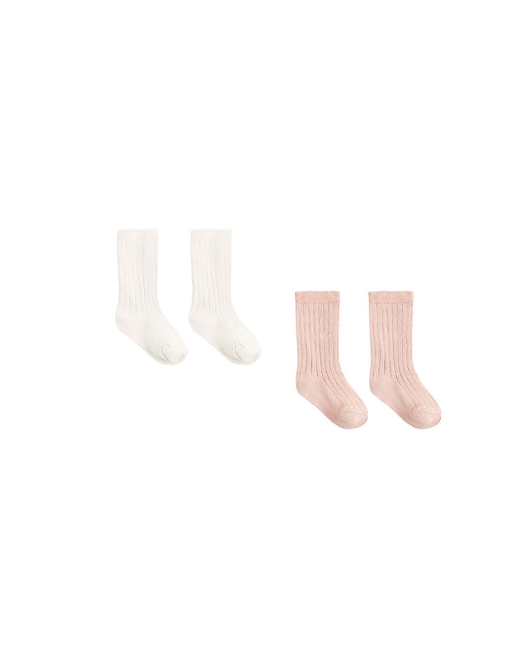 A set of two pairs of ribbed socks—one in natural and one in dusty rose—from quincy mae is displayed side by side on a plain white background. Made from soft organic cotton, this cozy baby socks set comes beautifully boxed, making it perfect for gifting or everyday wear.