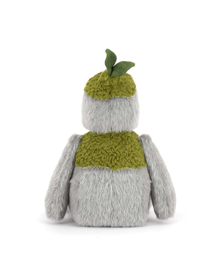 This Jellycat Rockleton is a polyester plush with shaggy light gray fur, olive green patches on its back and head, and two green felt leaves on top. It sits upright with its back shown.