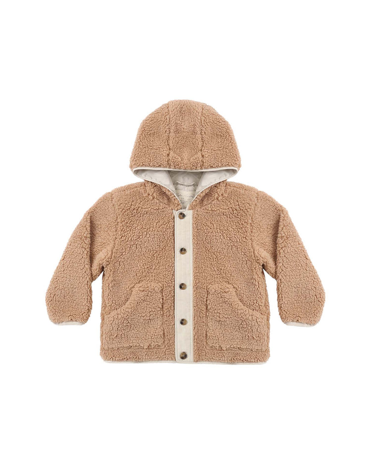 A “lodge jacket in fawn” by rylee + cru designed for kids is shown on a white background. This tan, hooded jacket is crafted from soft sherpa fleece and features a snug 3-piece hood, two front pockets, and a button-up front closure.