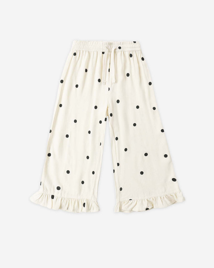 The rylee + cru wide leg pant in polka dot features white fabric with black polka dots, an elastic drawstring waist, and ruffled hems, shown laid flat on a white background.