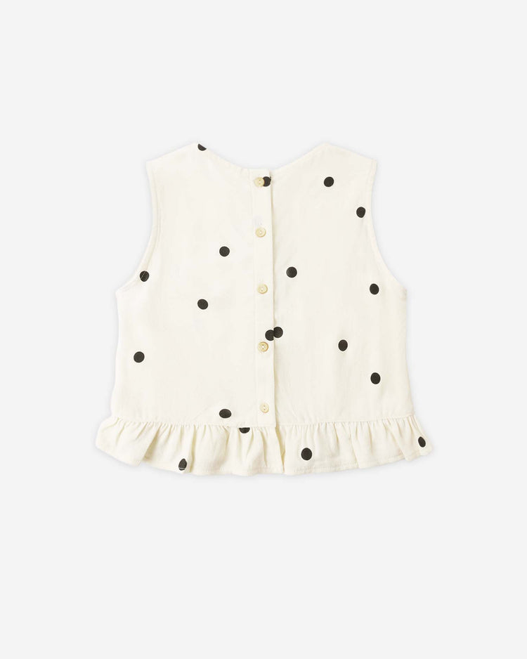 The oceanside top in polka dot by rylee + cru is a cream sleeveless cotton blouse with black dots, back buttons, and a ruffled hem—ideal for summer.
