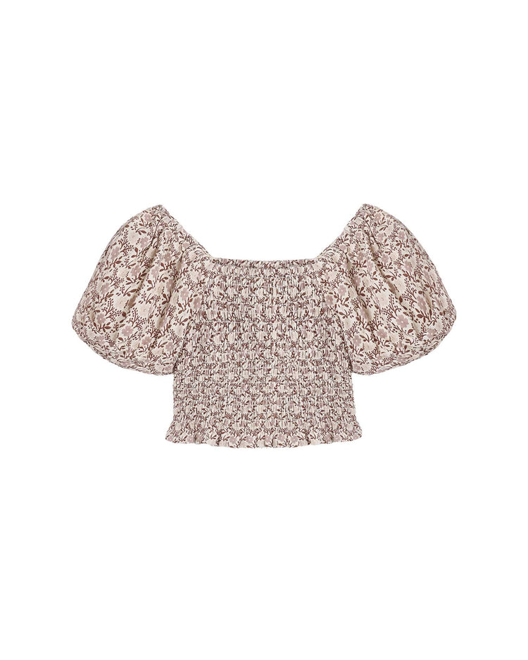 The trixie top in primrose by rylee + cru is a light, cropped, off-the-shoulder piece with puffed sleeves and a smocked bodice for added comfort and style. Designed with a delicate brown and beige floral pattern, this feminine top offers an effortlessly charming look.