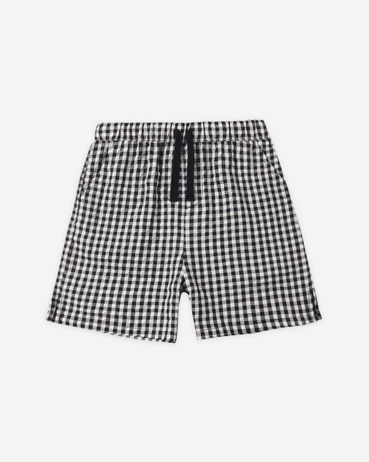 The rylee + cru perry short in black check features a black and white gingham pattern, elastic waistband, and black drawstring, shown laid flat on a white background for a subtle vintage vibe.