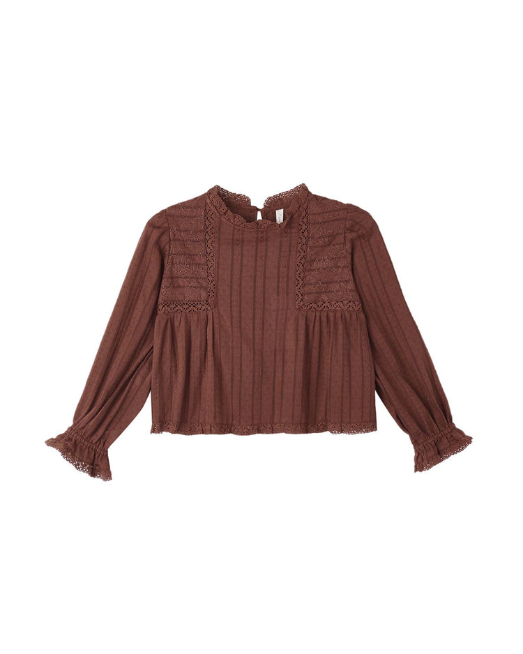 Embodying timeless elegance, the Cecile Blouse in Mulberry by rylee + cru is a long-sleeve cotton prairie top featuring delicate lace trim on the collar, chest, and cuffs. Subtle vertical stripes and a slightly flared hem and sleeves lend this brown blouse its effortlessly vintage-inspired silhouette.