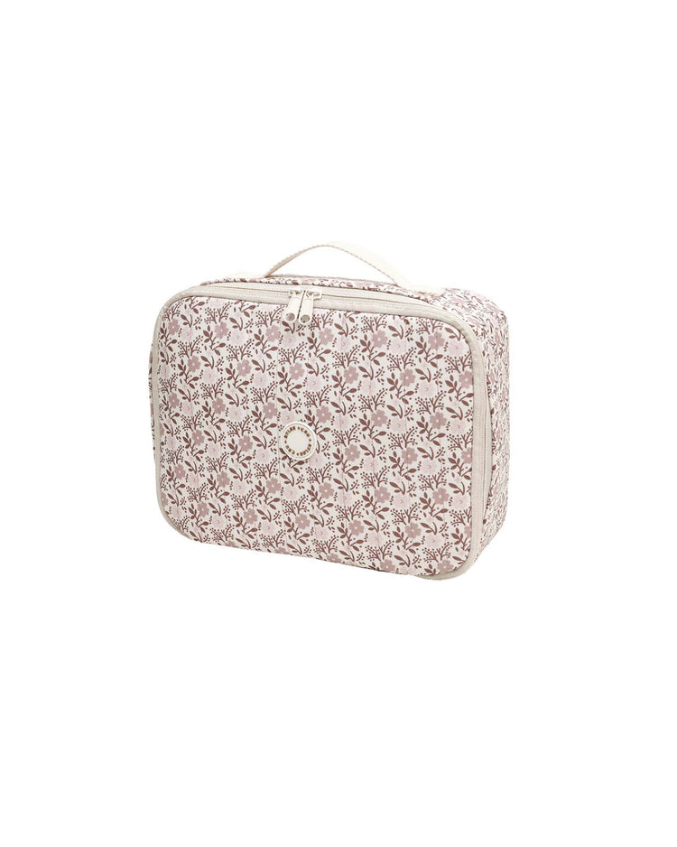 The "lunch bag in primrose" by rylee + cru features a rectangular zippered design with a pink and white floral pattern, beige trim, a small round logo centered on the front, and a beige handle on top. This stylish insulated lunch bag keeps your food fresh while you’re on the go. It is displayed against a plain white background.