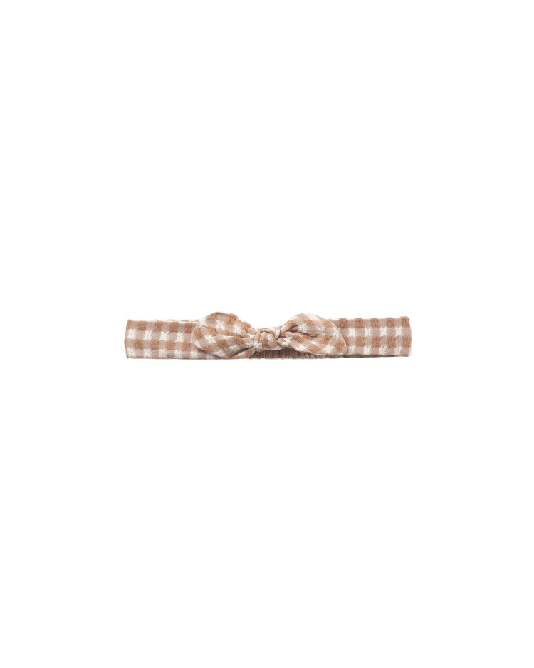 The rylee + cru baby bow headband in fawn gingham features a central knot design, crafted from 100% cotton fabric with a classic gingham pattern and shown against a plain white background.