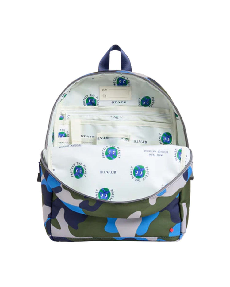 The kane backpack in camo by state bags features a main compartment that opens to reveal a white interior lining printed with blue and green globe and “STATE” logos—an ideal choice for fans of state bags who value both style and practicality.